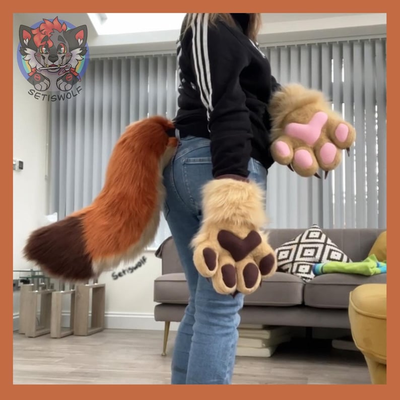 May include: A furry costume set featuring a fox tail and paw gloves. The tail is orange and brown, and the gloves are tan with pink and brown paw pads. The costume is designed for cosplay or themed events.