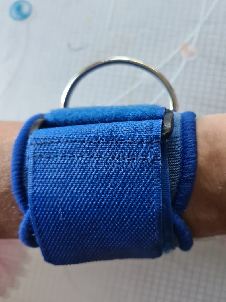 Abdl. BLUE RESTRAINTS. A Pair of Lockable Wrist Straps With Drings