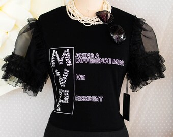 Making a difference stay positive and look chic, wearing our stylish embellished statement t-shirt with sheer ruffled organza sleeves.