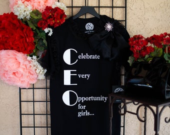 Future CEO’s take a BOW and look polished in this fabulous big bow, ruffles and brooch embellished statement t-shirt