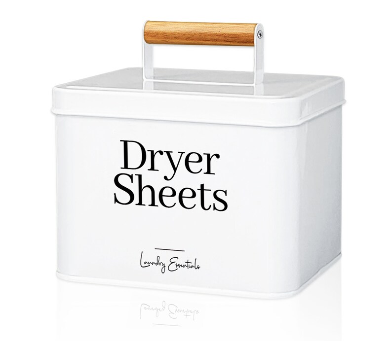 May include: White metal storage container with a wooden handle. The container has a black label that says "Dryer Sheets" and "Laundry Essentials".