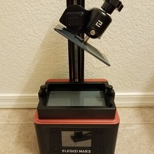 Elegoo Mars resin 3D printer with angled build plate drain hanger installed, resin drip holder allowing resin to flow back into the vat after printing, accessory compatible with Elegoo Mars, Mars Pro and Mars 3 resin printers