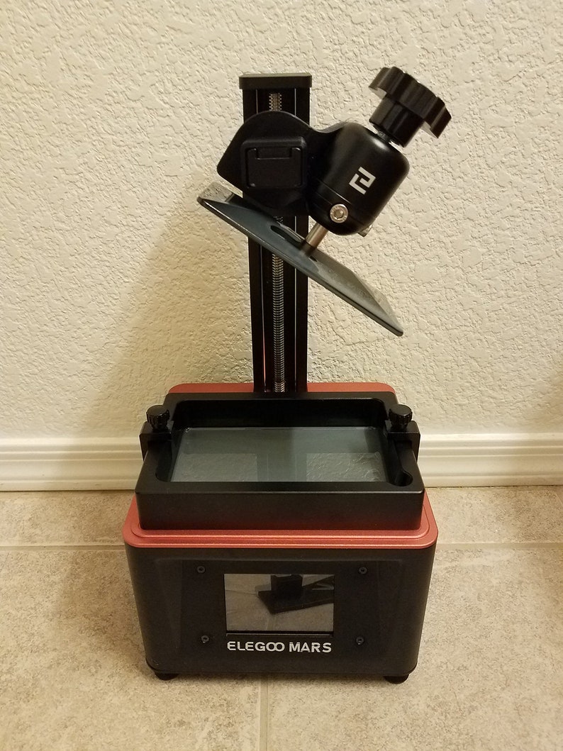 Elegoo Mars resin 3D printer with angled build plate drain hanger installed, resin drip holder allowing resin to flow back into the vat after printing, accessory compatible with Elegoo Mars, Mars Pro and Mars 3 resin printers