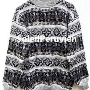 May include: A gray, black, and beige alpaca sweater with a geometric pattern. The sweater has a crew neck and long sleeves.