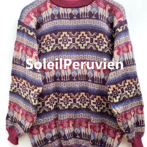 May include: A burgundy alpaca wool sweater with a colorful geometric pattern featuring llamas and trees. The sweater has a crew neck and long sleeves.
