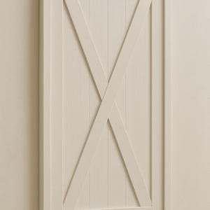 May include: A rectangular, off-white wooden wall decor piece with a framed border. The design features vertical planks and a prominent X-shaped overlay, creating a rustic, farmhouse aesthetic. The piece is mounted on a neutral-toned wall.