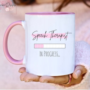May include: White ceramic mug with a pink rim and handle. The mug has a pink stripe and the text "Speech Therapist" with a progress bar that says "In Progress..."