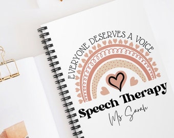 May include: A white spiral notebook with a pink and brown rainbow design. The rainbow has hearts around it and the text "Everyone Deserves a Voice" and "Speech Therapy Ms. Sarah". The bottom of the notebook has the text "By Jackie Designs".