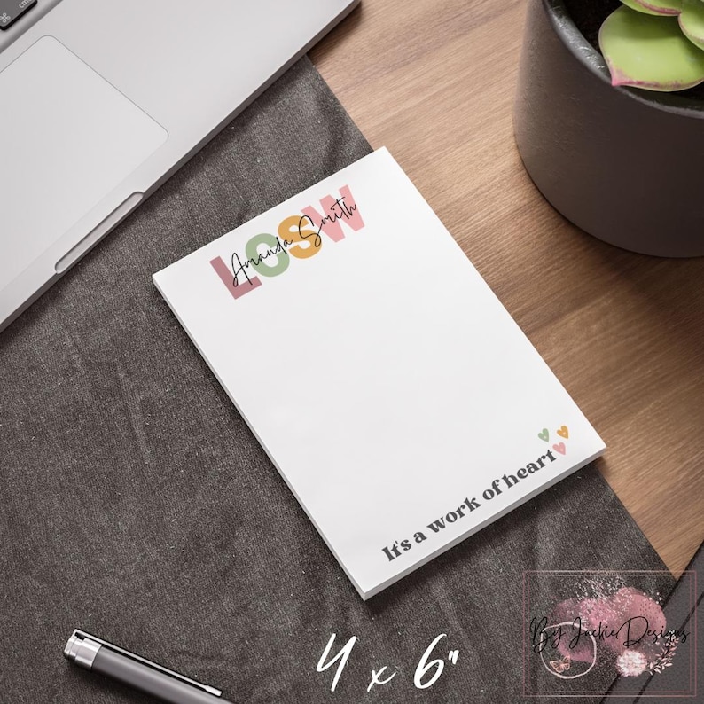 May include: A white notepad with the text "Amanda Smith" in pink, green, and orange, and the words "It's a work of heart." The notepad measures 4 x 6 inches.