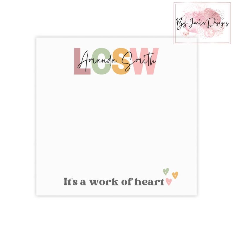 May include: A white notepad with the text "LOOSW Amanda Smith" in colorful letters. Below, it reads "It's a work of heart" with small heart illustrations. The notepad has a watercolor design in the upper right corner.
