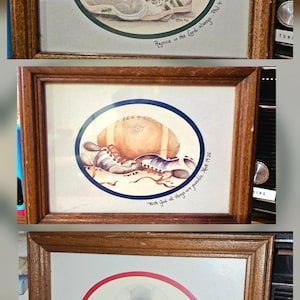 May include: Three framed watercolor paintings featuring sports equipment. The top frame shows a basketball and sneakers, the middle frame shows a football and cleats, and the bottom frame shows a soccer ball and cleats. Each frame has a scripture quote.