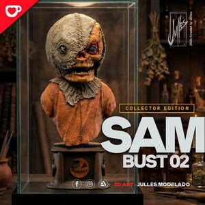 May include: A Sam bust 02 collector edition figure encased in a glass display box. The figure features a burlap-textured head with a button eye, a stitched mouth, and an orange fabric-like torso. The base displays a carved pumpkin icon.