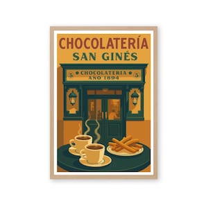 May include: A framed print featuring a vintage illustration of Chocolatería San Ginés, a historic chocolate shop. The image shows the shop's facade, two cups of coffee, and a plate of churros. The text includes "CHOCOLATERÍA SAN GINÉS" and "AÑO 1894".