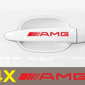 May include: Four red "AMG" decals for car door handles. The decals are red with white outlines and are designed to fit on the handle of a car door.