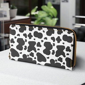 Cartera de piel sintética con cremallera y estampado de vaca lechera