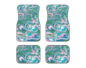 May include: Set of four car floor mats with a swirling abstract pattern in shades of green, blue, pink, and white.