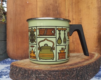 Vintage green one handle enameled pot decorated with kitchen motifs in the folk art style made in Yugoslavia