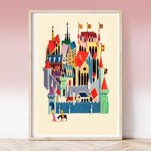 May include: A framed print featuring a colorful, stylized illustration of a medieval castle town. The artwork showcases a variety of buildings with red, blue, and yellow roofs, and includes a figure on horseback. The overall aesthetic is reminiscent of a vintage children's book illustration.