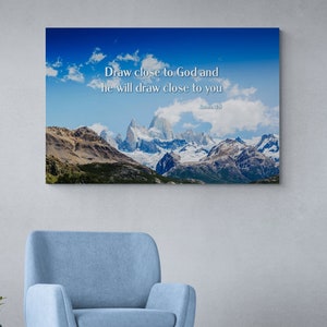 May include: A canvas print featuring a mountain range and a blue sky. The text "Draw close to God and he will draw close to you" is printed on the canvas. The text "James 4:8" is printed below the quote.
