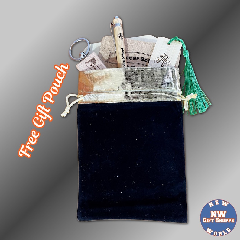 May include: A black velvet gift pouch with a gold drawstring, filled with a pen, keychain, cork pieces, and a wooden tag with a green tassel. The pen and tag have text on them. The words "Free Gift Pouch" are written on the left side.