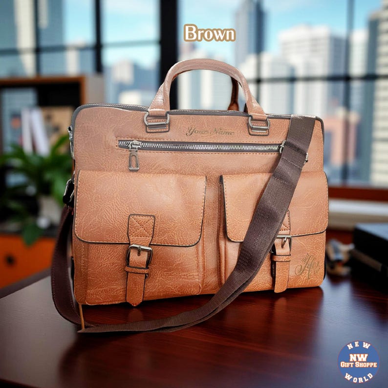 A brown vegan leather briefcase with two front buckled pockets, a top zipper, and two handles, rests on a dark surface.