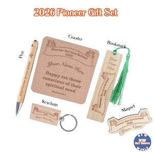 May include: A 2026 Pioneer Gift Set featuring a pen, coaster, bookmark, keychain, and magnet. The items are made of wood and have the text "Pioneer Service School 2026" and "Your Name Here". The coaster has a quote from Matthew 5:3.
