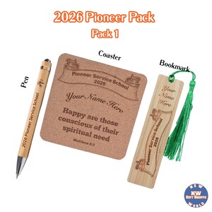 May include: A gift set including a pen, coaster, and bookmark. The pen is wooden with black ink. The coaster and bookmark are brown with text that reads "Pioneer Service School 2026" and "Happy are those conscious of their spiritual need."