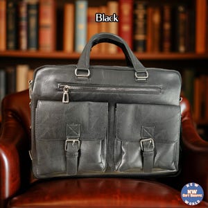 A black vegan leather briefcase with two front buckled pockets, a top zipper, and two handles, rests on a brown leather chair.