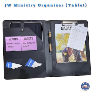 May include: Black leather folder with a built-in tablet holder, two pockets for tracts, and a clipboard with a magazine and a form. The folder has the text "JW Ministry Organizer (Tablet)" on the front.