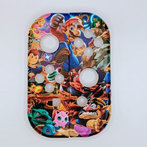 May include: A colourful Nintendo Switch Joy-Con controller skin featuring various characters from popular video games, including Mario, Link, Pikachu, and Donkey Kong.
