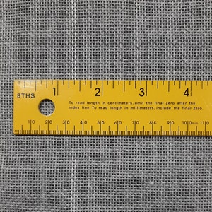 May include: A yellow ruler with black markings and the text "8THS" and "To read length in centimeters, omit the final zero after the index line. To read length in millimeters, include the final zero." The ruler is marked in centimeters and millimeters from 1 to 4.