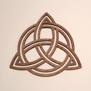 May include: A wooden Celtic knot, also known as a Trinity knot, is a decorative design with three interlocking loops. The knot is a symbol of unity, strength, and eternity.