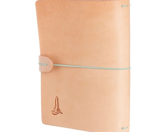 May include: A light brown leather notebook with a light blue elastic closure and a small lighthouse logo embossed on the front cover.