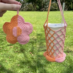 May include: Two crocheted flower-shaped items in pink and orange. One is a small flower charm, the other is a larger cup holder with a handle.