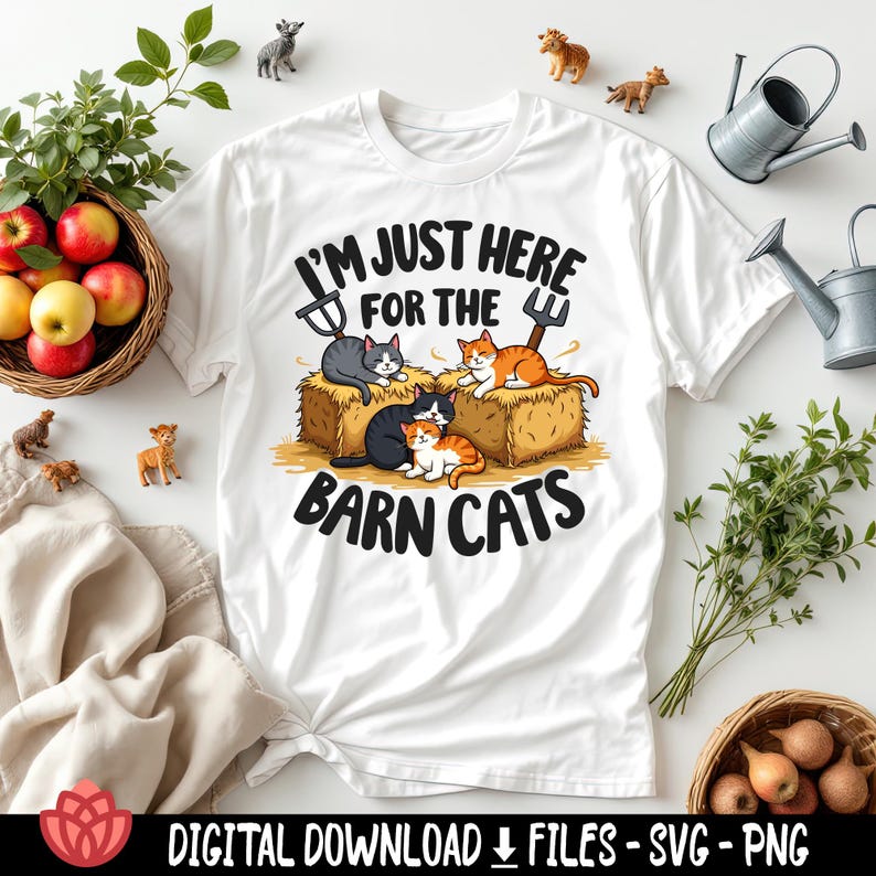 May include: White t-shirt with the text "I'M JUST HERE FOR THE BARN CATS" and a graphic of four cats on hay bales. The cats are gray, orange, and black. The shirt is surrounded by miniature farm animal figurines, apples, and watering cans.