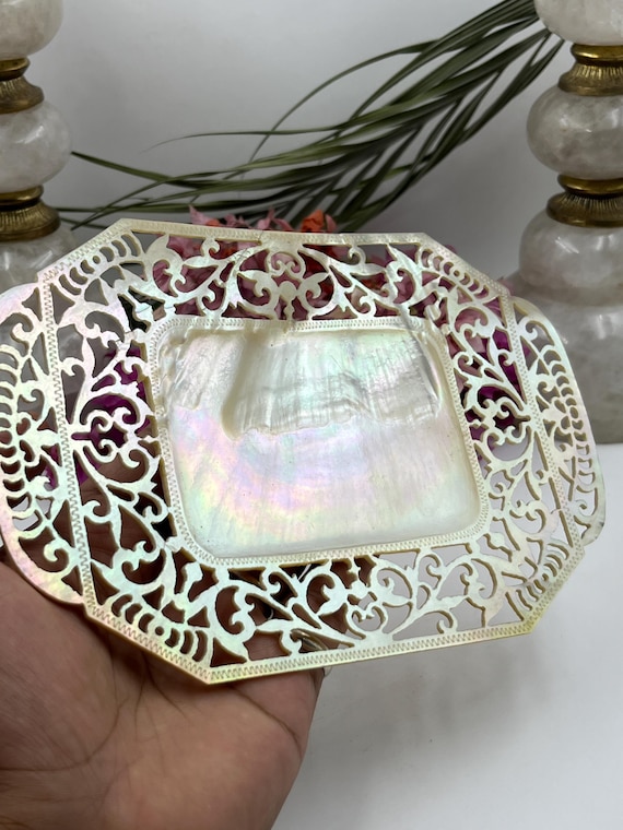 Intricately hand-carved mother-of-pearl tray with medieval-style perforated detailing — the kind of one-of-a-kind artisan object that looks like it belongs in a Renaissance cabinet of curiosities.