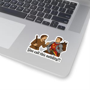 May include: A sticker featuring a cartoon illustration of two figures. One figure, holding a stick, points at the other, who is dressed in armor and riding a horse. The text "You call this nobility?!" is below the figures.
