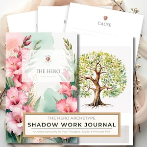 May include: A collection of journals and cards. The journal cover features pink flowers and the text "THE HERO". The journal is labeled "THE HERO ARCHETYPE SHADOW WORK JOURNAL". The cards have the words "R" and "CAUSE".