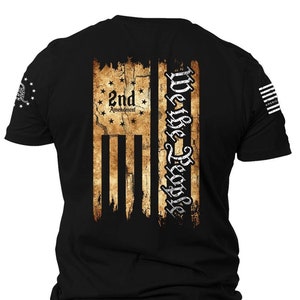 May include: Black t-shirt with a distressed American flag design. The flag has the text "We the People" and "2nd Amendment" printed on it.