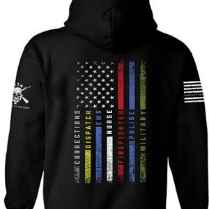 May include: Black hooded sweatshirt with a thin American flag design on the back. The flag is made up of thin stripes of yellow, blue, red, white, and green. The words "Corrections", "Dispatch", "EMS", "Nurse", "Firefighter", "Police", and "Military" are printed vertically on the stripes. The words "American Dad" are printed on the right sleeve.