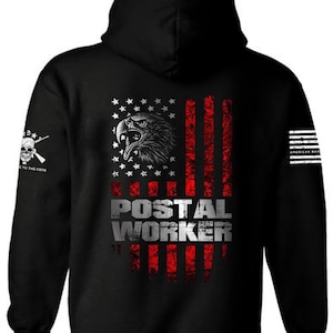 May include: Black hooded sweatshirt with a distressed American flag design featuring a bald eagle and the text "POSTAL WORKER".