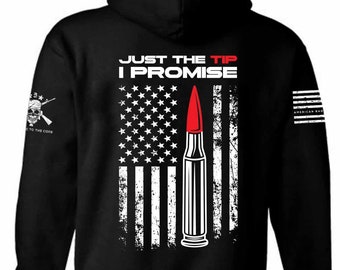 May include: Black hooded sweatshirt with a distressed American flag design and a red bullet with the text "Just the Tip I Promise" in white.