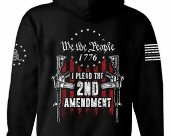 May include: Black hooded sweatshirt with a red, white, and blue American flag design. The text "We the People 1776 I Plead the 2nd Amendment" is printed on the back of the sweatshirt.
