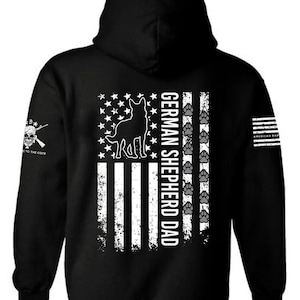 May include: Black hooded sweatshirt with a white American flag design featuring a German Shepherd silhouette and the text "German Shepherd Dad".
