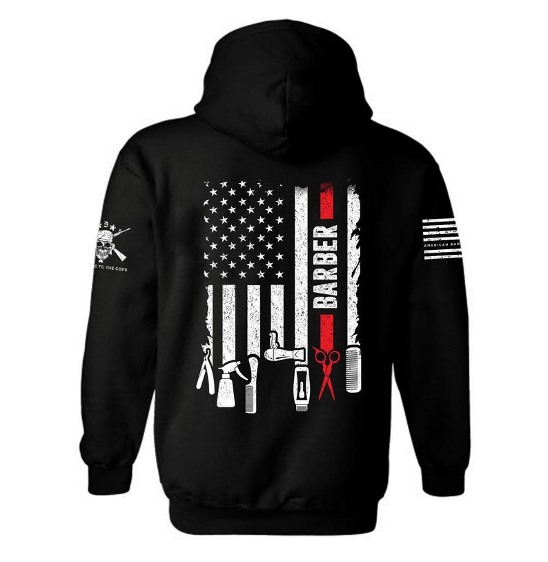 May include: Black hooded sweatshirt with a white American flag design and the word "BARBER" in red. The flag has a red stripe down the right side and white barber tools on the left side.