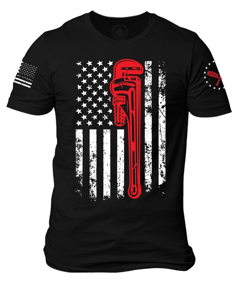 May include: Black t-shirt with a distressed American flag design featuring a red wrench. The flag has white stars on a blue field and red and white stripes.