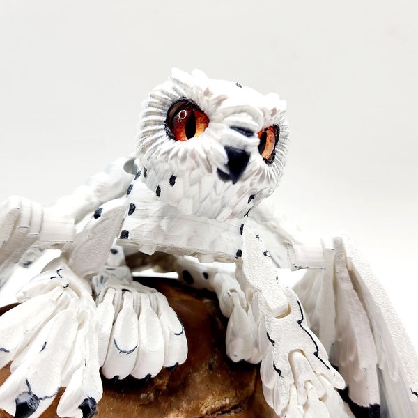 3D printed articulated Snow Gryphon fidget desk toy.