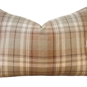 May include: A brown and beige plaid cushion with a soft, textured fabric.