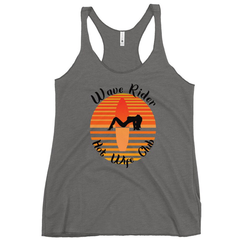 May include: Gray racerback tank top with a graphic featuring a sunset design with a surfboard and a silhouette of a person. The text reads "Wave Rider Hot Wife Club" in a stylized font.