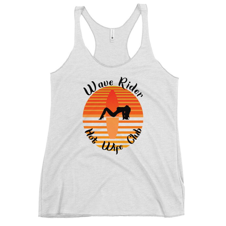 May include: A light gray racerback tank top with a graphic. The graphic features a silhouette of a person on a surfboard, set against an orange and yellow sunset design. Text reads "Wave Rider Hot Wife Club."